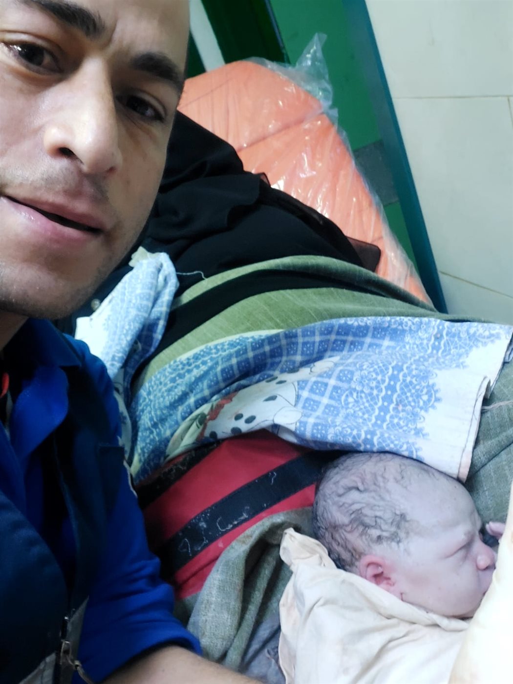 طاقم سيارة الإسعاف مع المولود بمحطة القطار