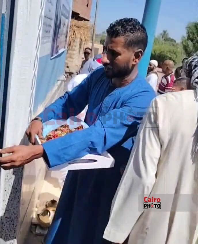قبطي يوزع حلوى على المصلين خلال افتتاح مسجد في قنا
