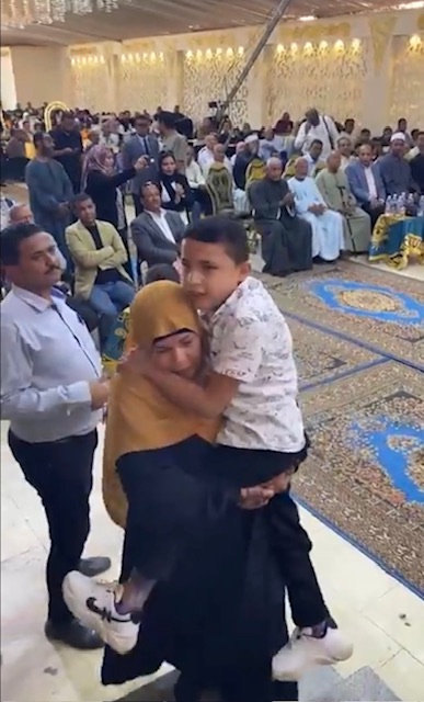 حملت إبنها على كتفها لتسلم تكريمة