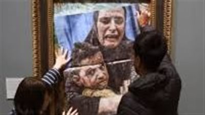 نشطاء يضعون صورة لأم فلسطينية وصغيرها فوق لوحة بيكاسو بالمعرض الوطني في لندن