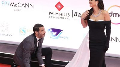 محمد فراج “يفرد” لبسنت شوقي فستانها بـ”القاهرة السينمائي” (فيديو)