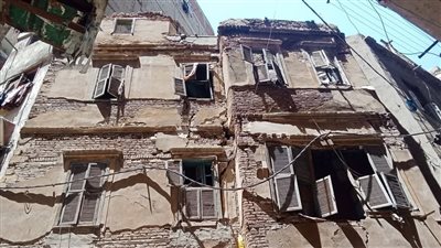استجابة لشكاوى المواطنين.. حي الجمرك يزيل أجزاء خطرة ومعلقة بأحد العقارات القديمة