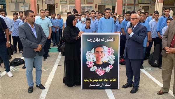 سيدة تحمل صورة ابنها